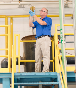 wastewater operator observing coagulation using polymer